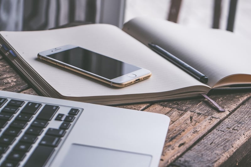 Businesswoman with Smartphone and Notebook